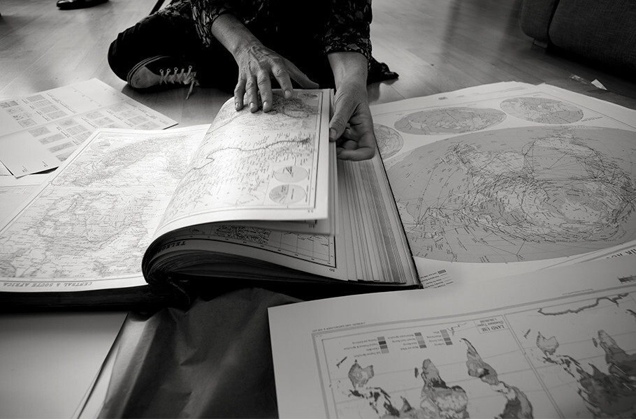 woman with book of maps