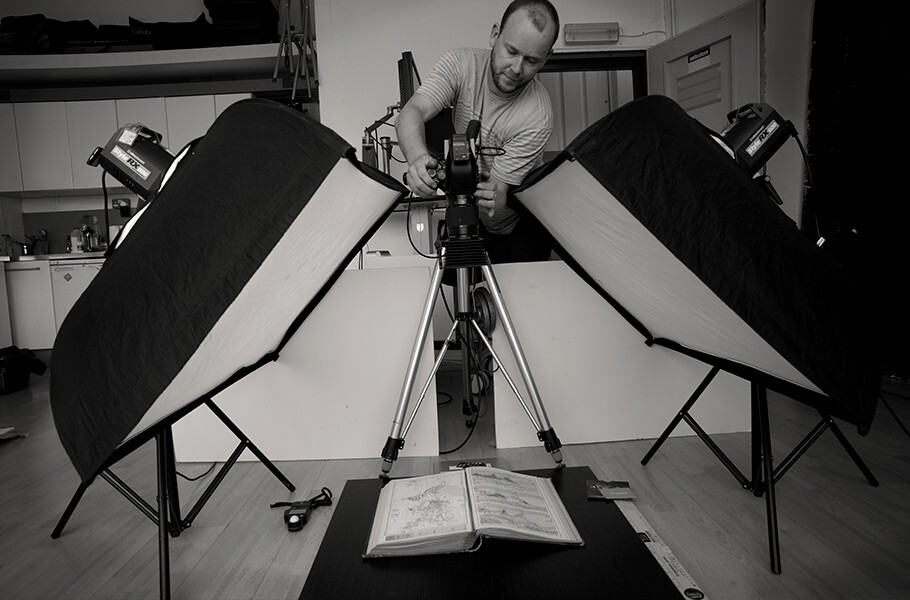man photographing book