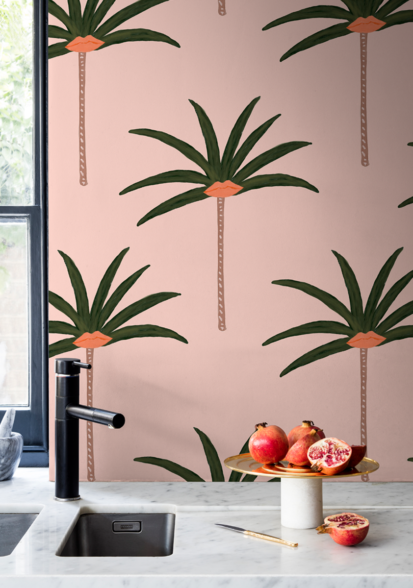 'Palm Tree Lips' from the Bouffants and Broken Hearts collection by Kendra Dandy, printed as a tropical palm tree print wallpaper in a modern kitchen