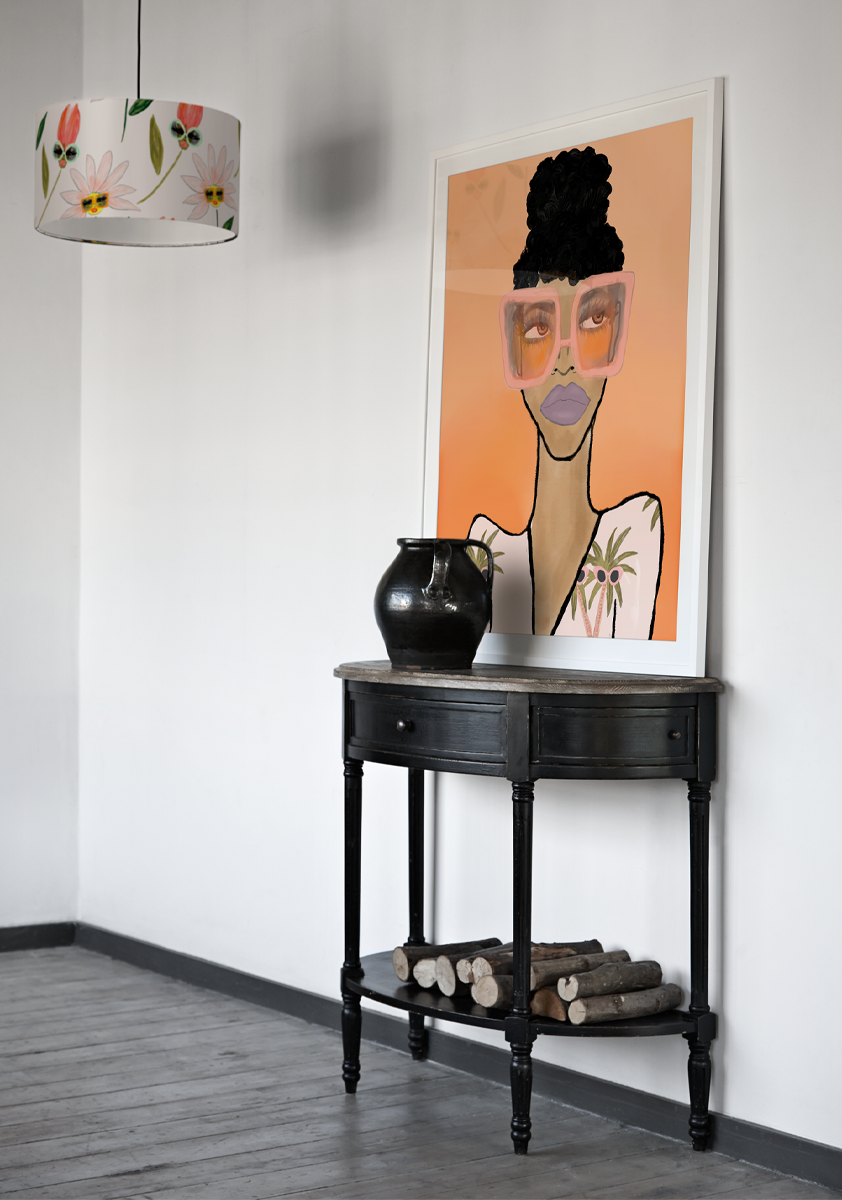 'Fashion Girl' from Bouffants and Broken Hearts by Kendra Dandy is a portrait of a woman wearing sunglasses and purple lipstick against an orange background, displayed in a modern monochrome interior
