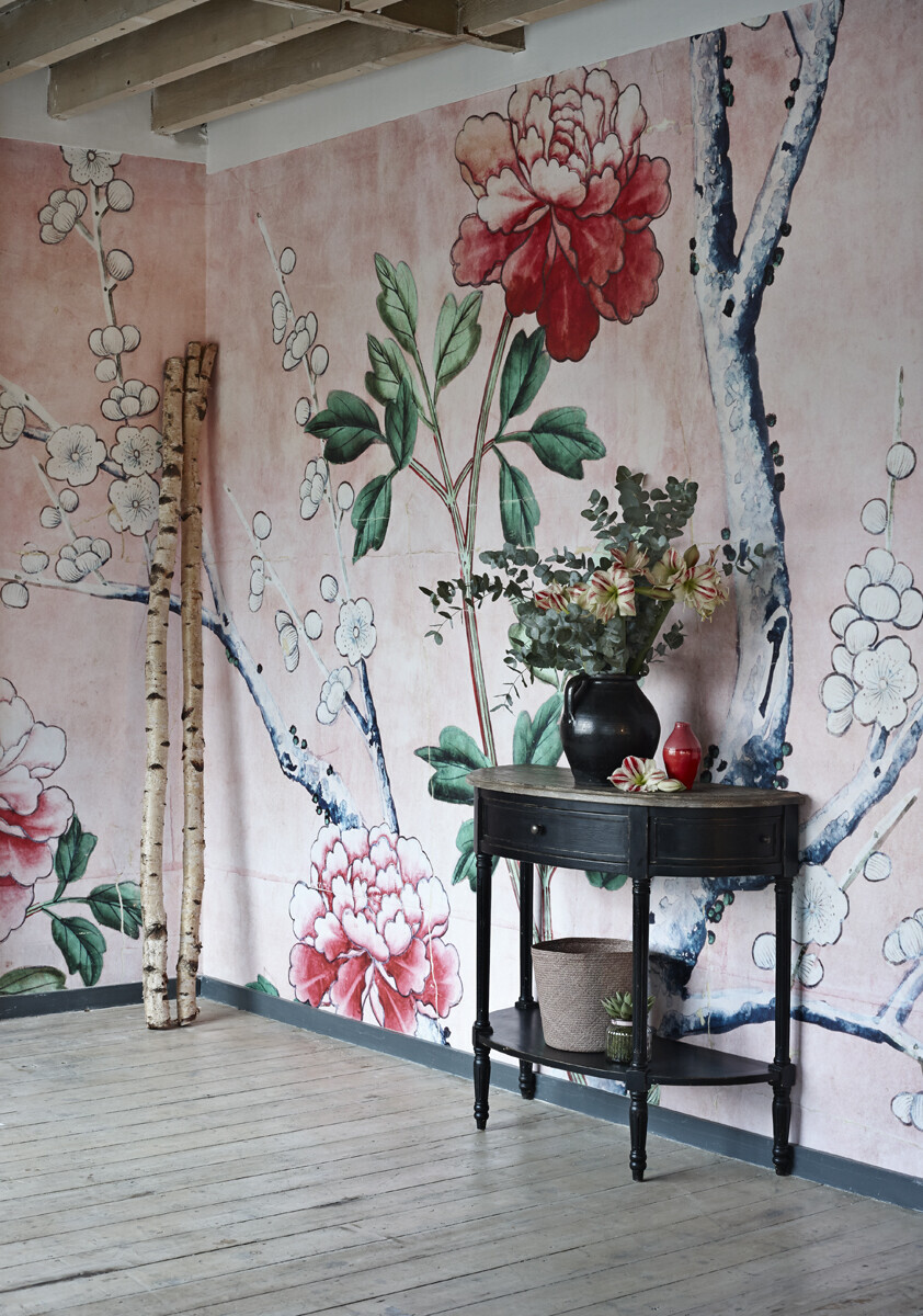 A beautiful pink chinoiserie wallpaper mural in a modern interior