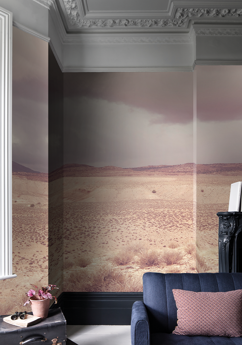 Pink wallpaper mural showing a pink desert landscape in a pink living room