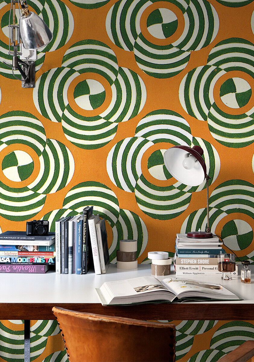 Russian textile print wallpaper with bright orange and bold green in circular patterns