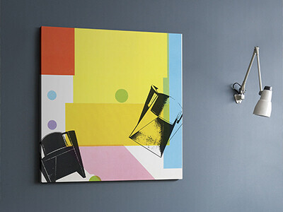 Retro 1986 furniture graphic, printed as a canvas in black on yellow and blue blocks of colour, hanging on a blue wall