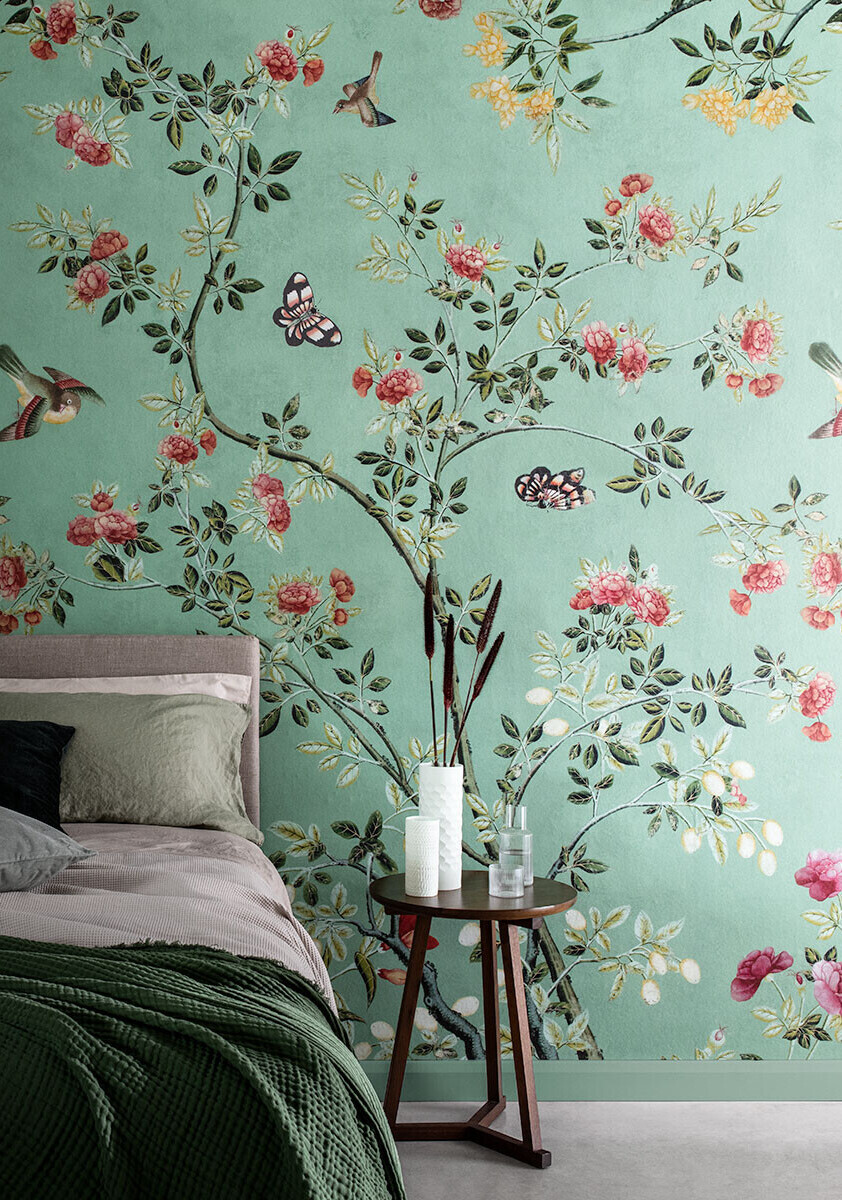 Jade green chinoiserie pattern wallpaper behind bed 