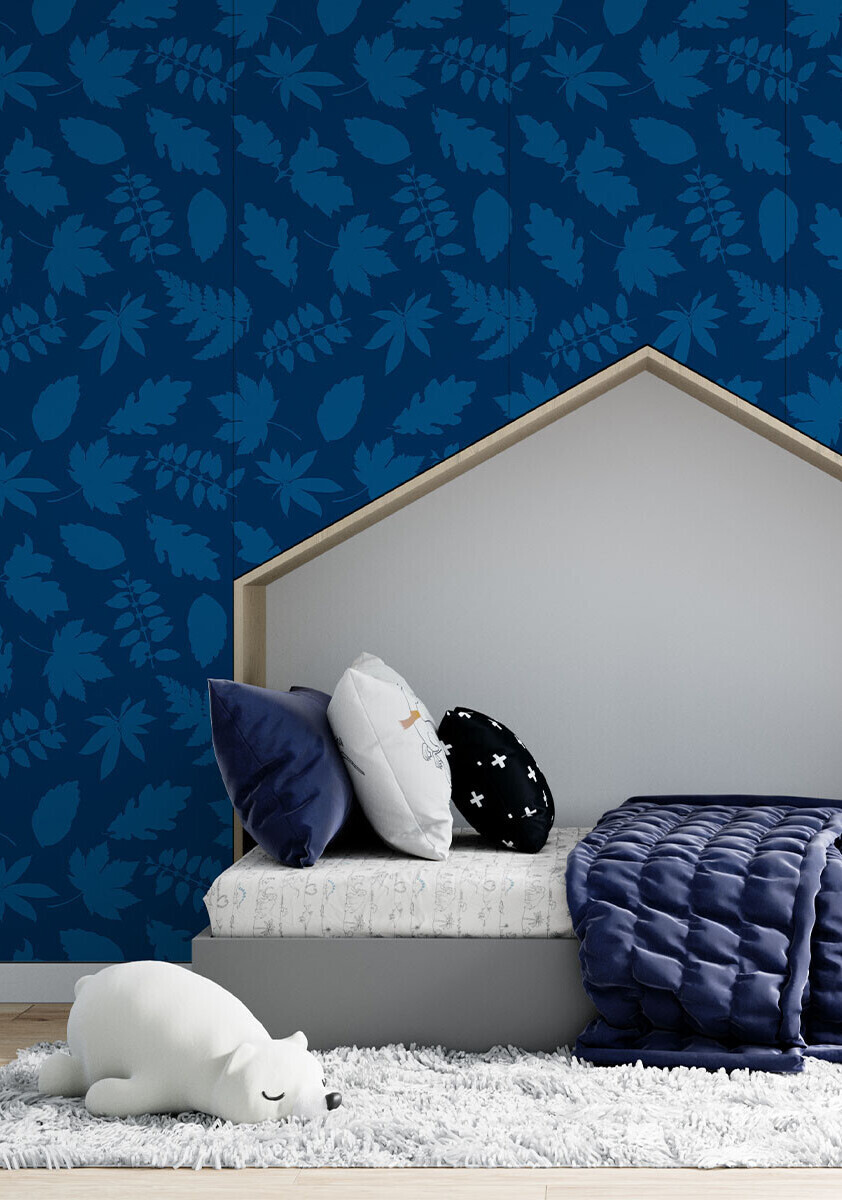 Repeating pattern of a variety of falling autumn leaves in an indigo two-tone blue